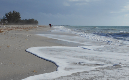 A beach with waves crashing on it.