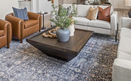 A living room with a couch and chairs.