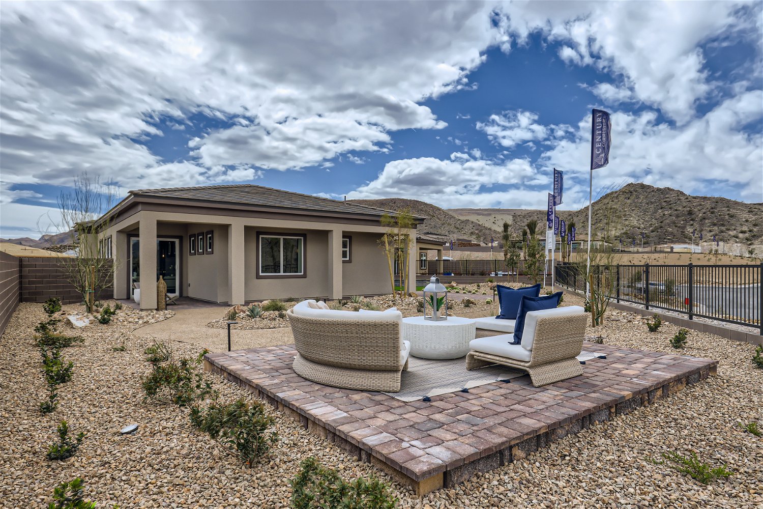 A house with a pool and chairs.