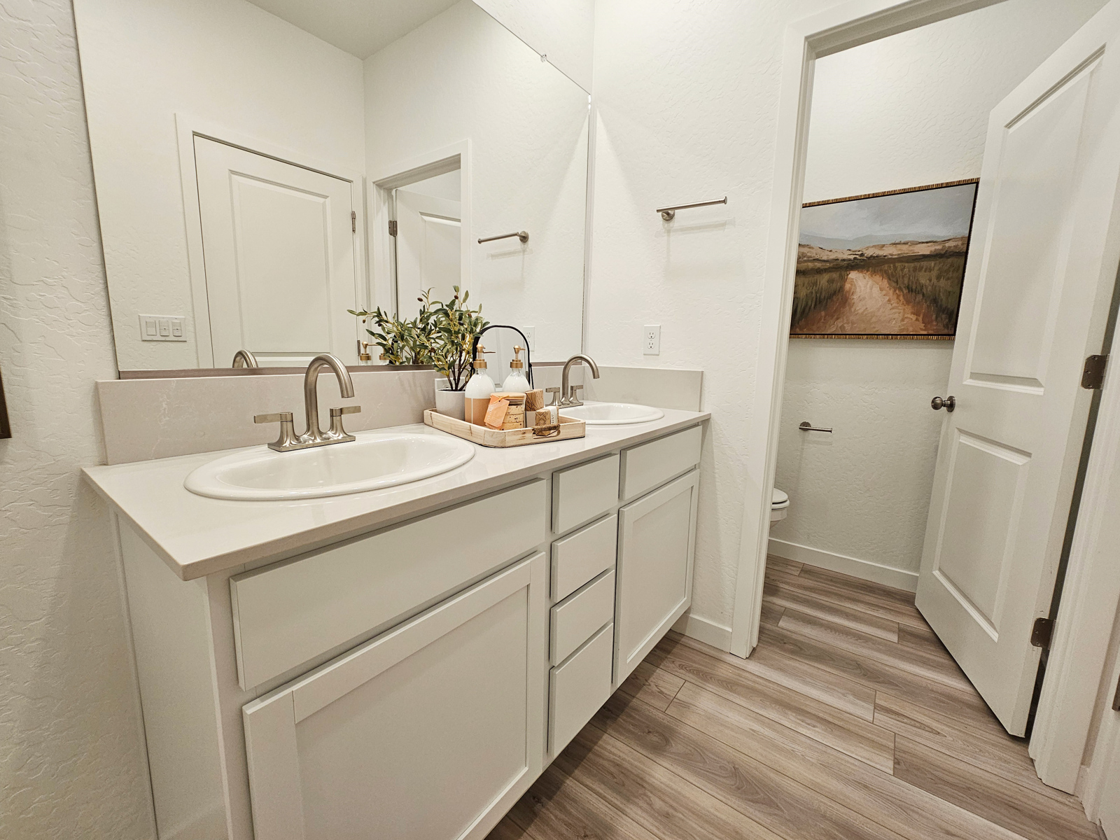 A bathroom with white cabinets.