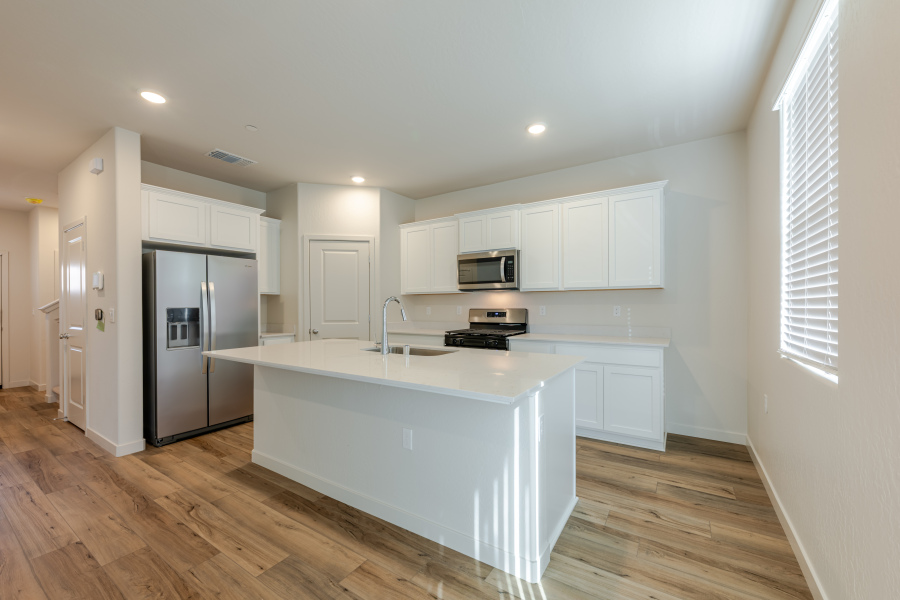 A kitchen with white cabinets.