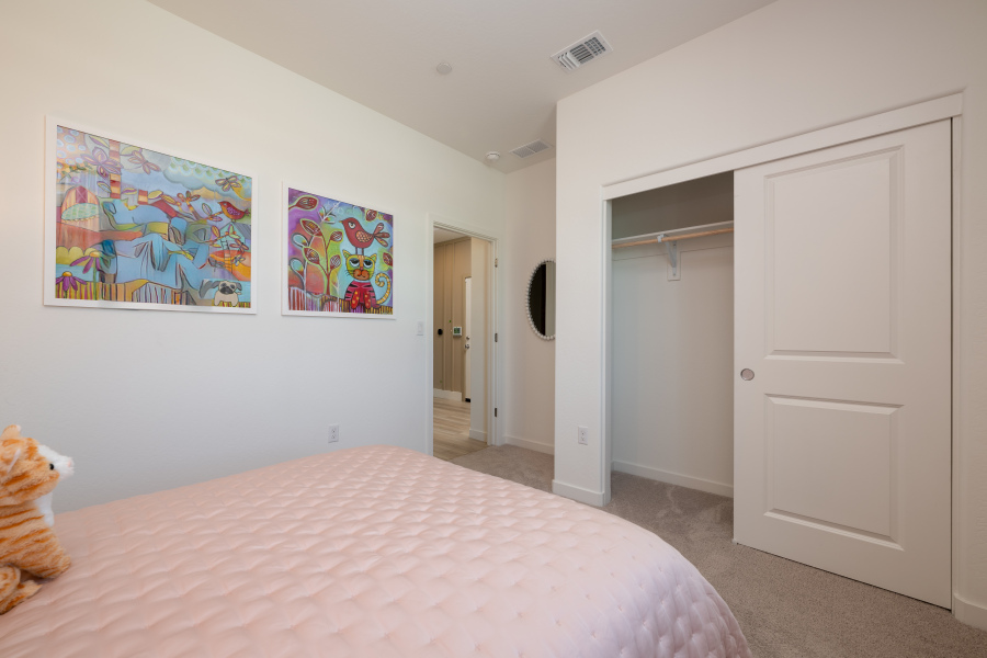 A bedroom with a bed and a door.