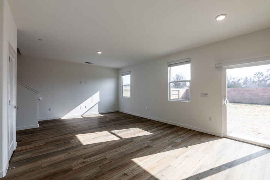 A room with a wood floor and windows.