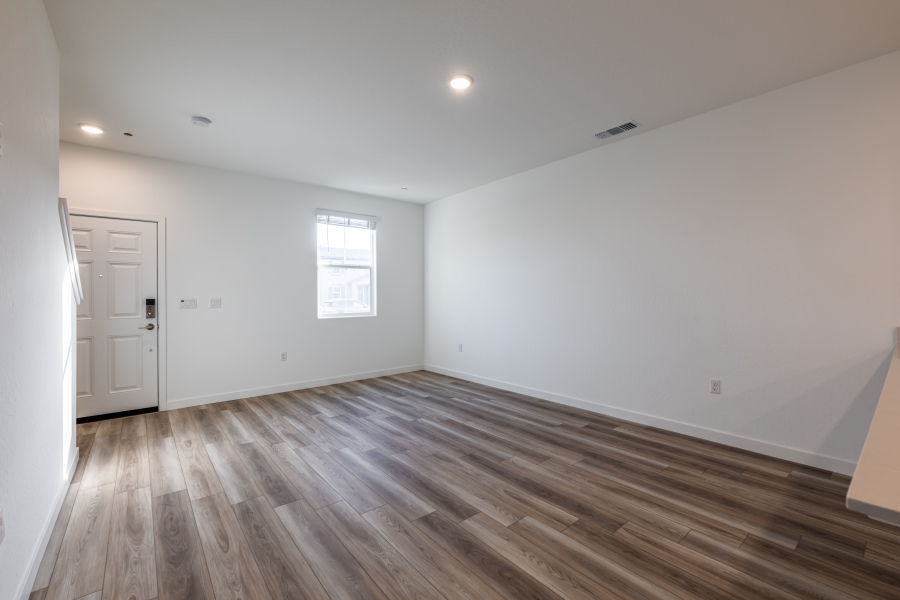 A room with a wood floor and white walls.