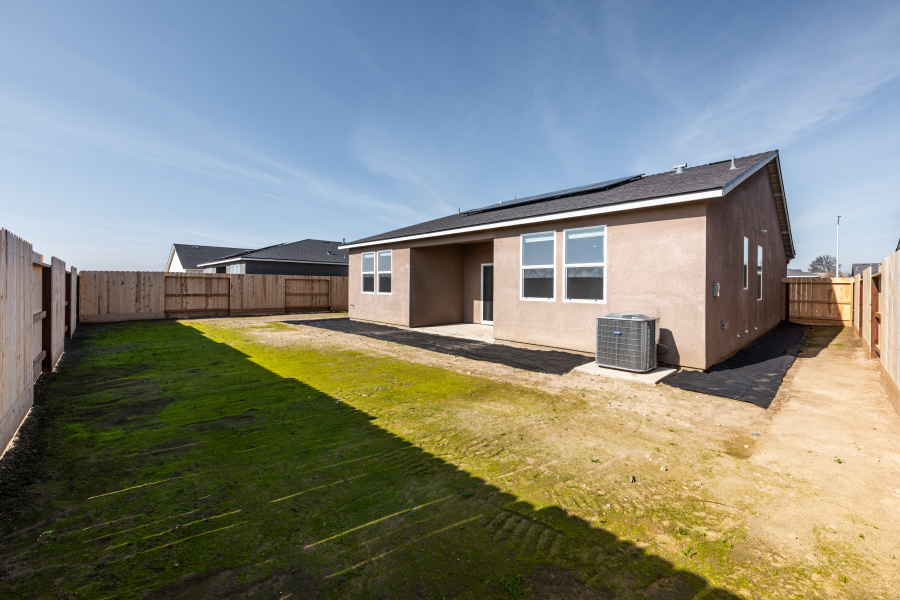 A house with a fence and grass.