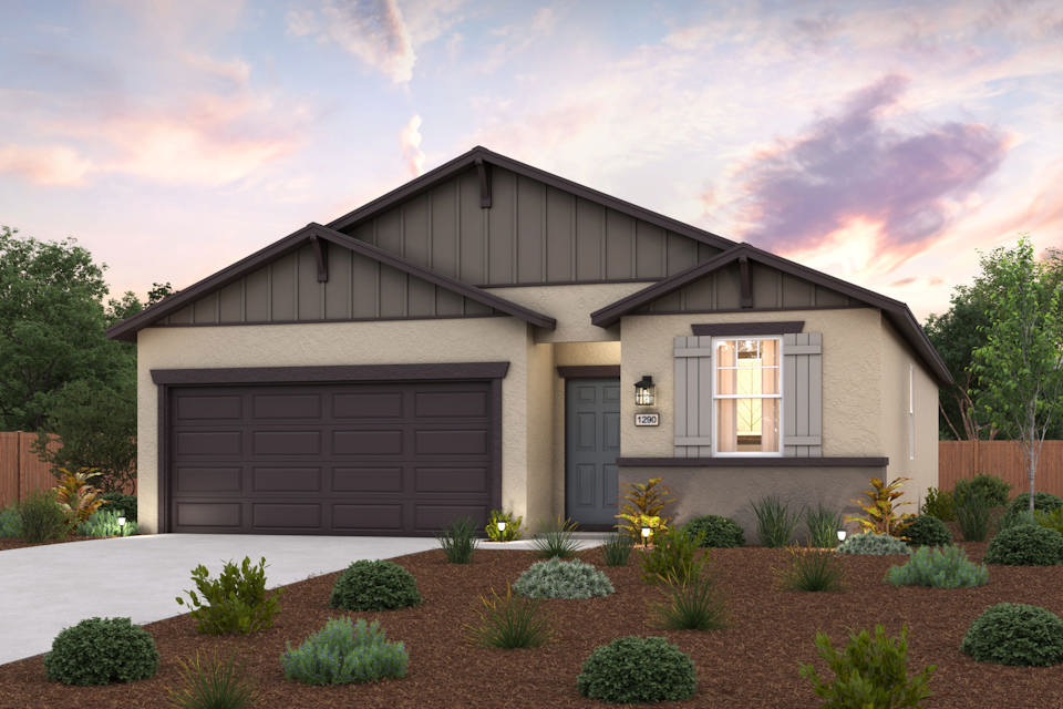 A house with a garage and bushes.