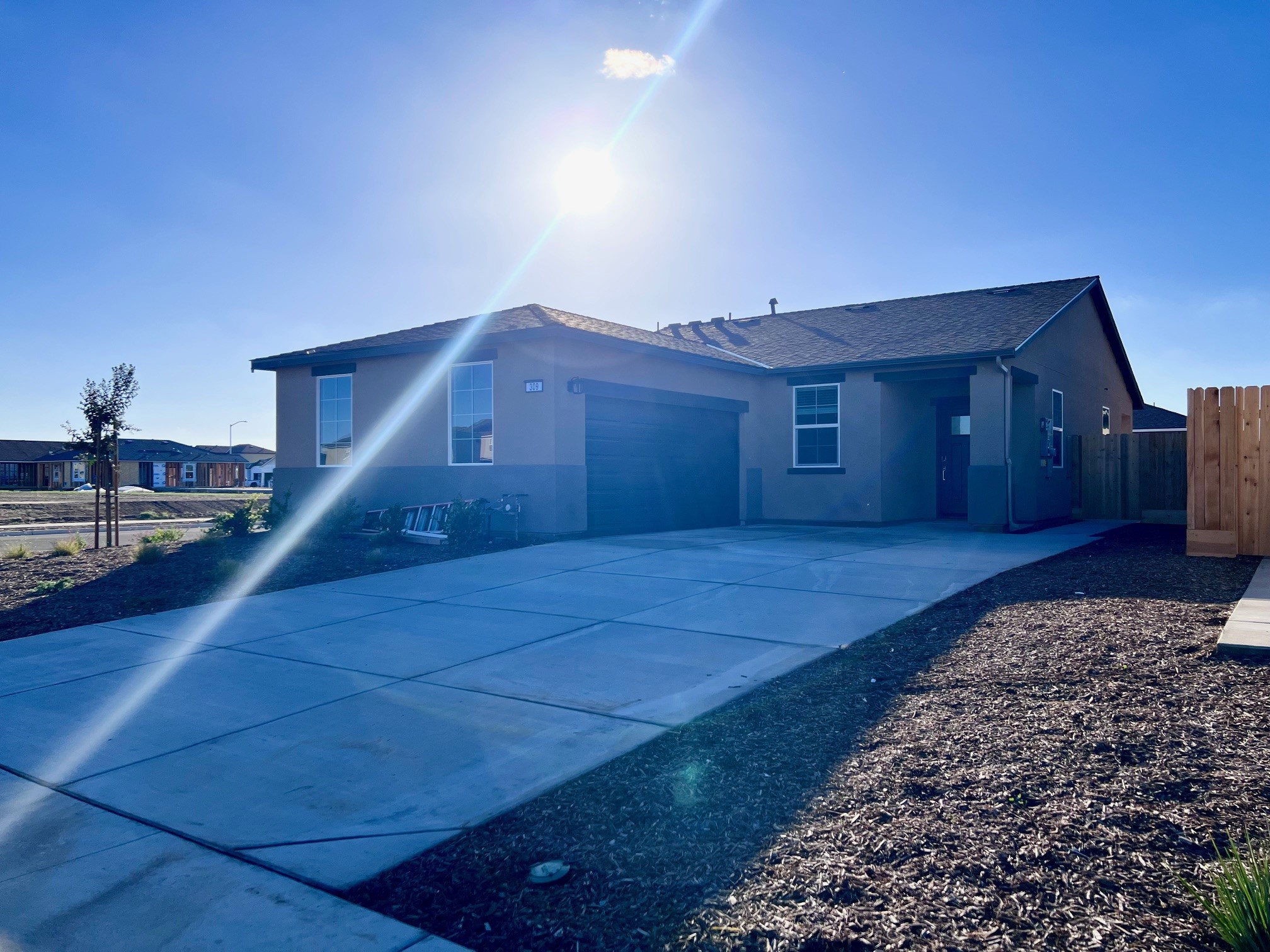 A swimming pool in front of a house.