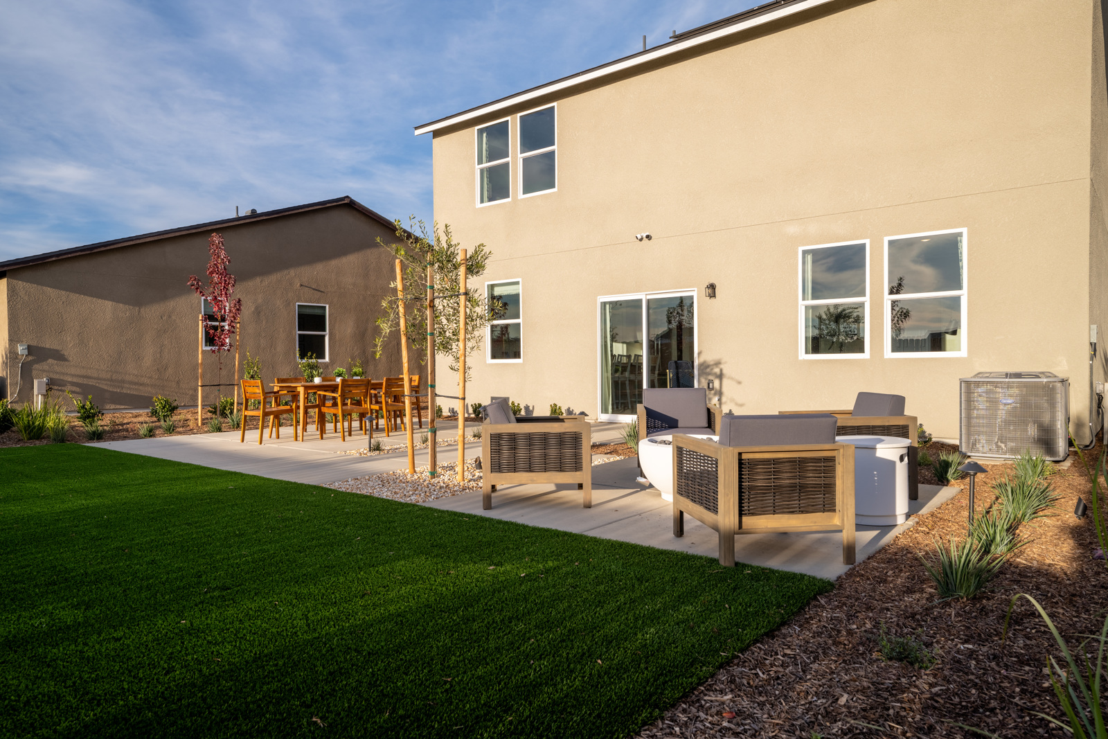A backyard with a picnic table and chairs.