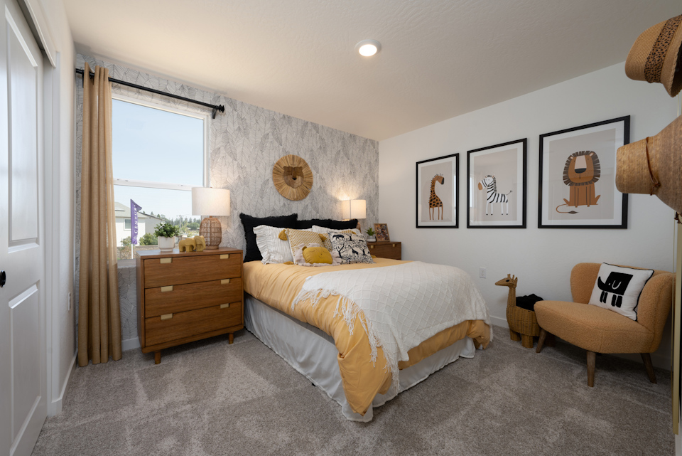 A bedroom with a bed and a chair.