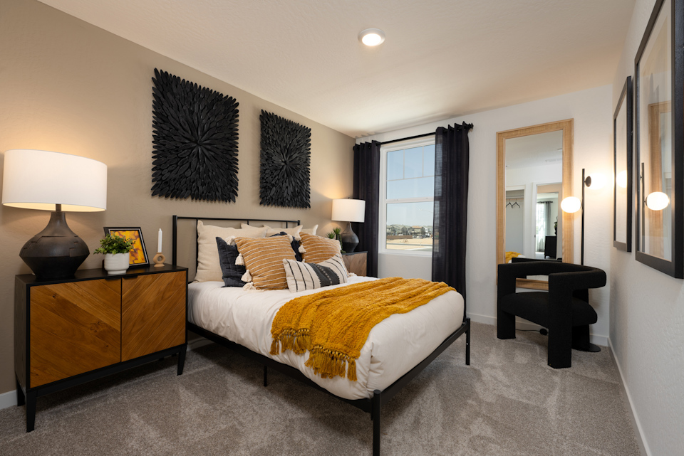 A bedroom with a bed and a desk.