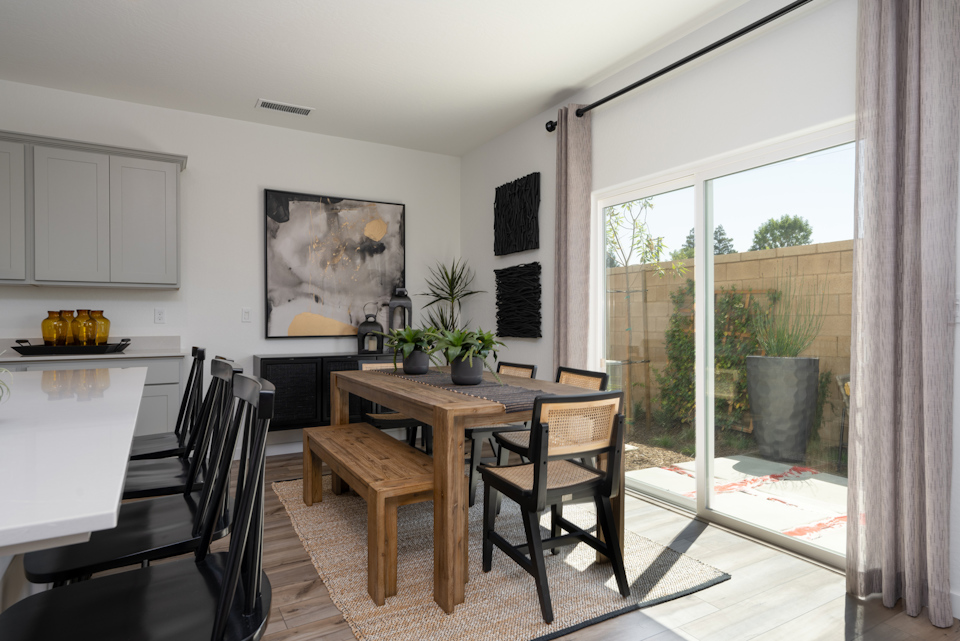 A dining room with a table and chairs.