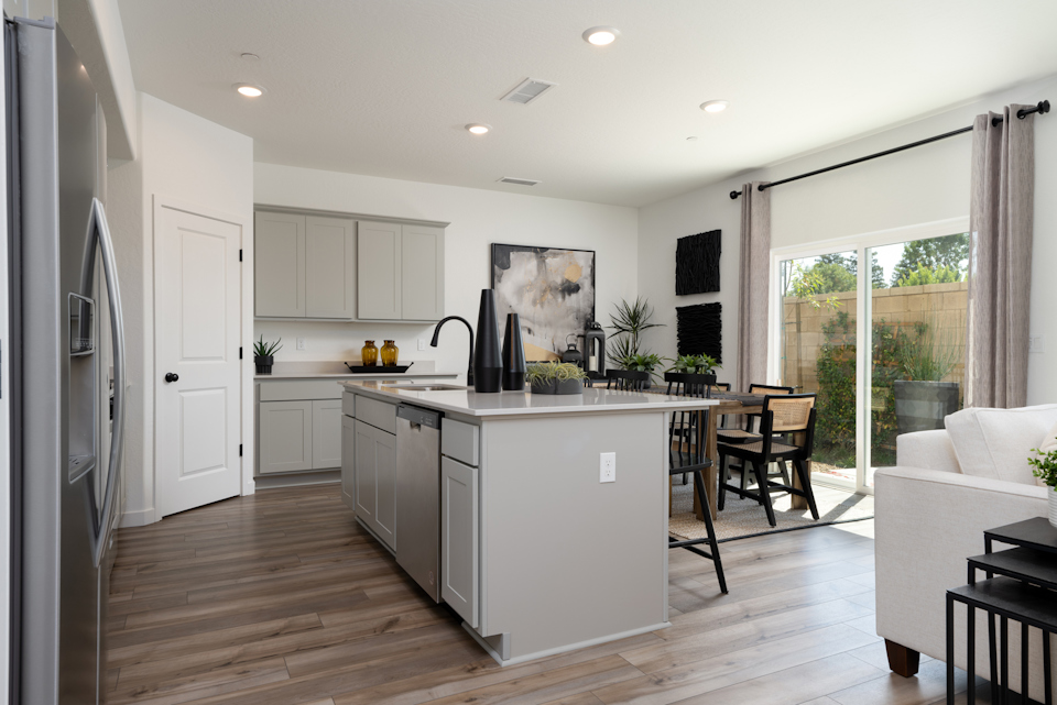 A kitchen with white cabinets.