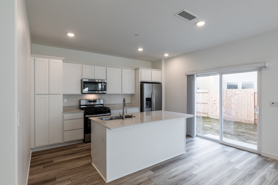 A kitchen with white cabinets.