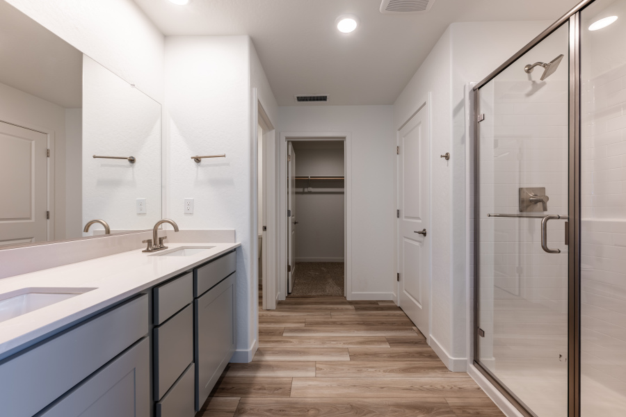 A bathroom with white cabinets.