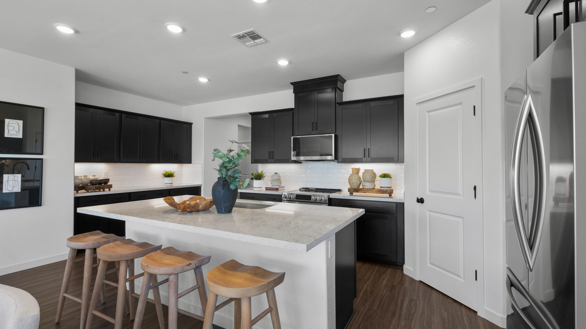 A kitchen with black cabinets.