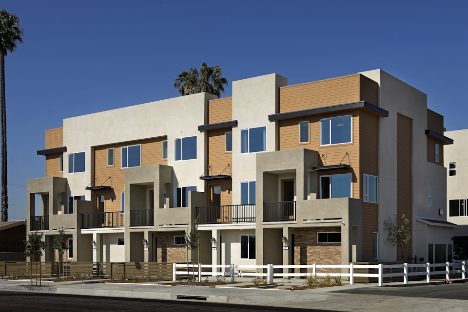 A large building with a white fence.