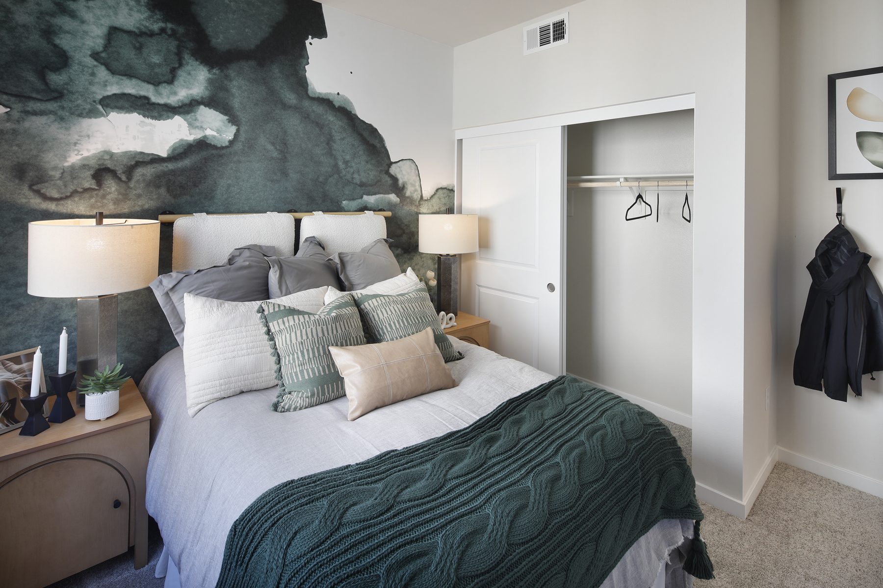 A bed with a blue blanket.