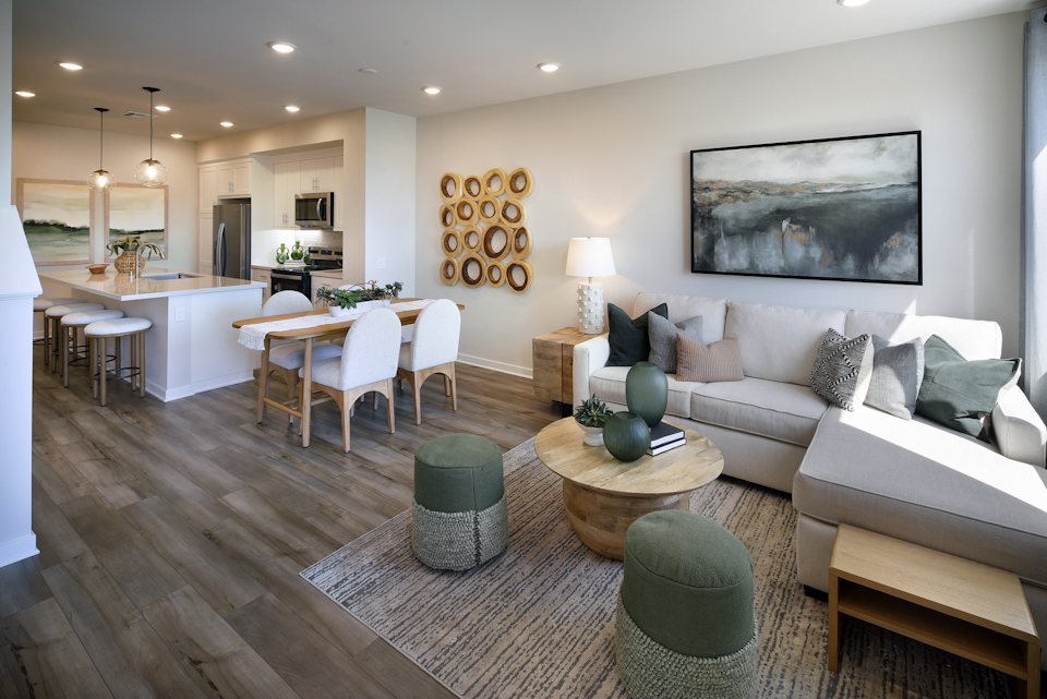 A living room with a large dining table and couches.
