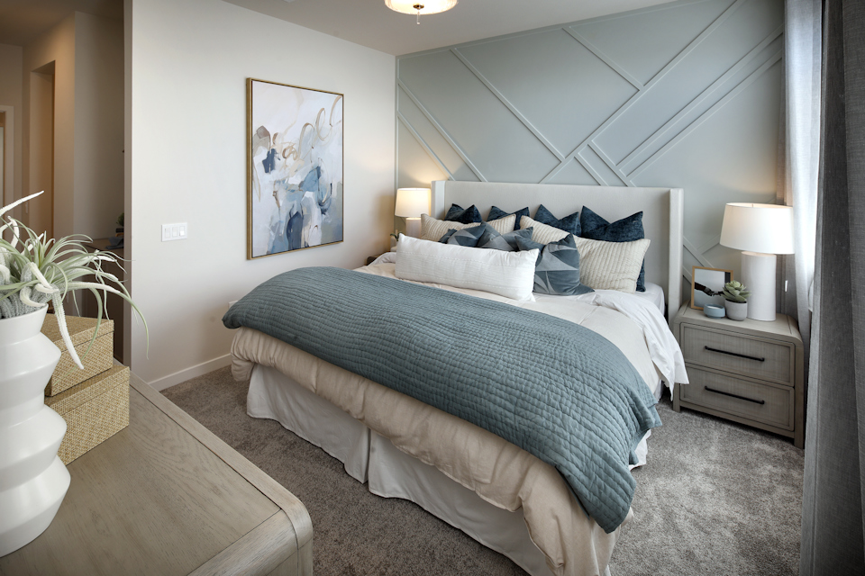 A bedroom with a bed and lamps.