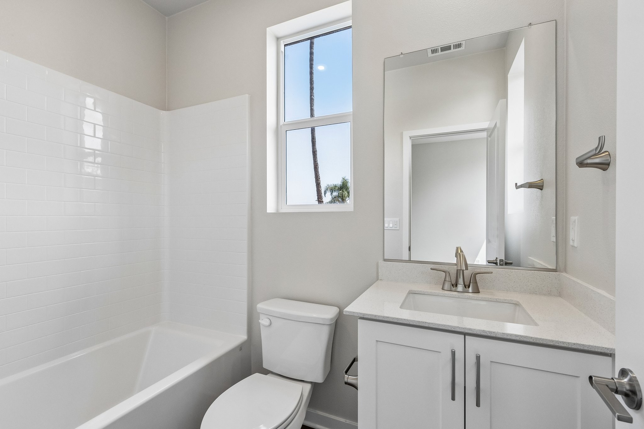 A bathroom with a tub sink and toilet.