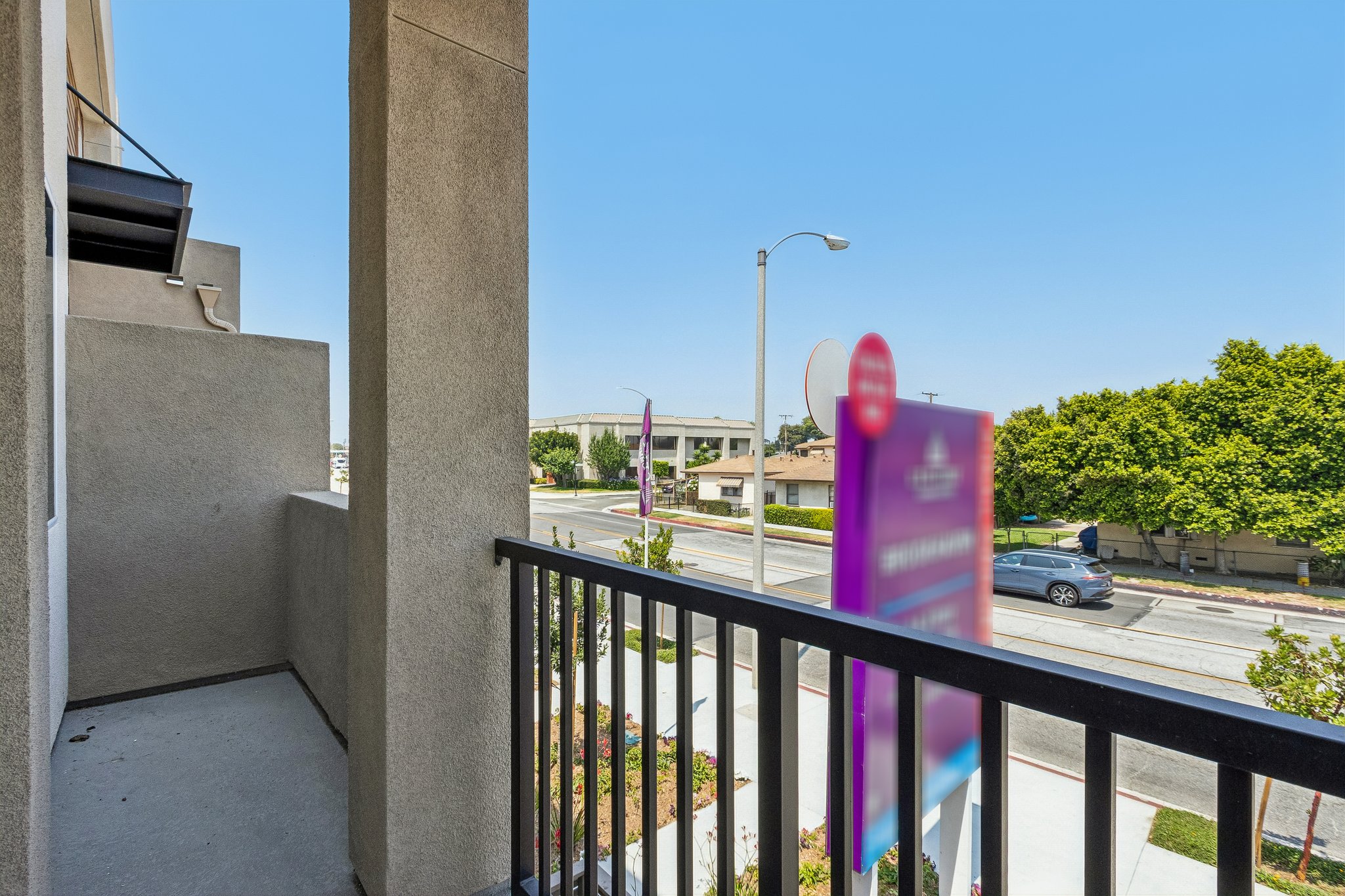 A parking lot with a pink sign.