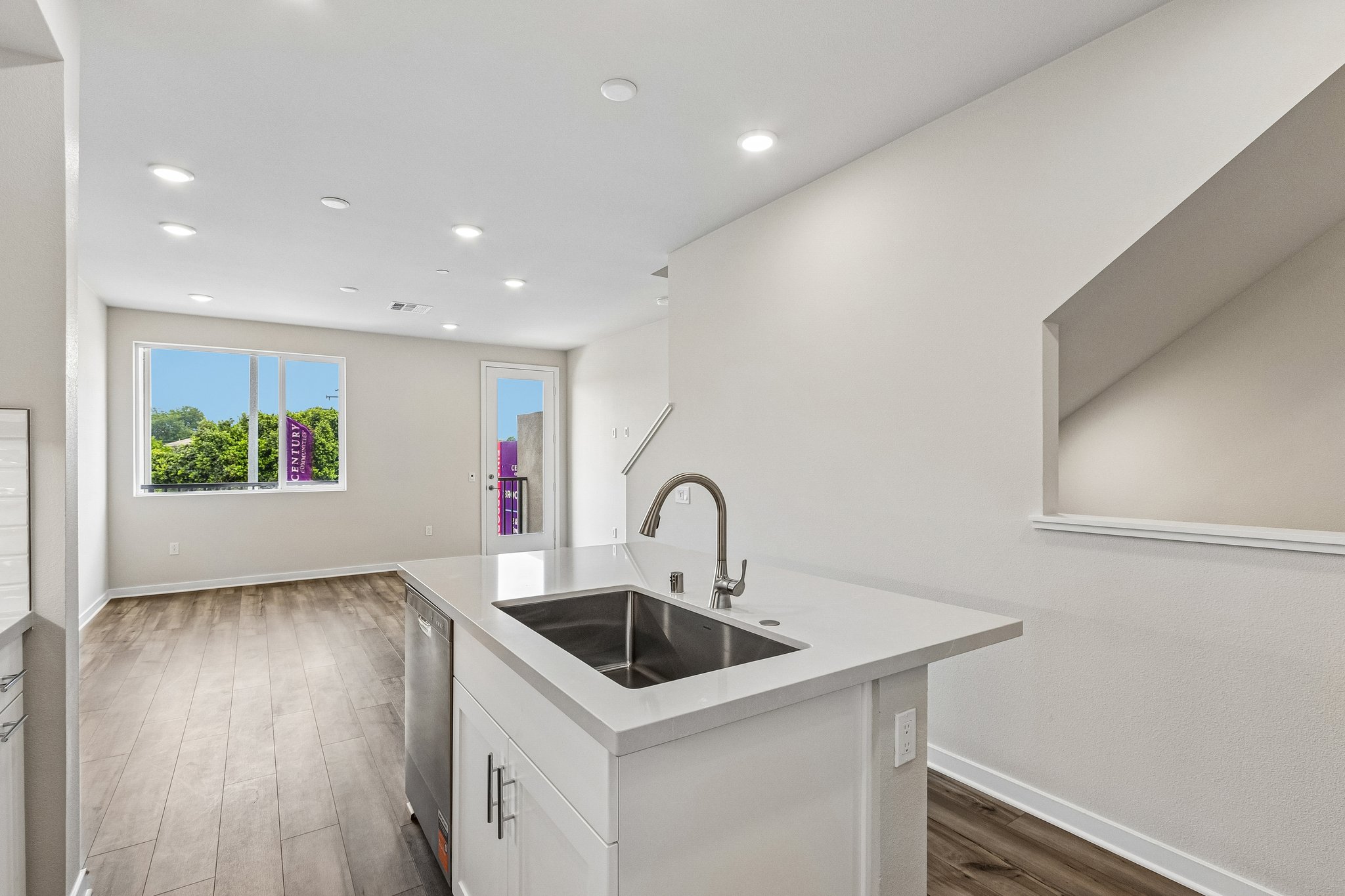 A kitchen with a sink and a window.