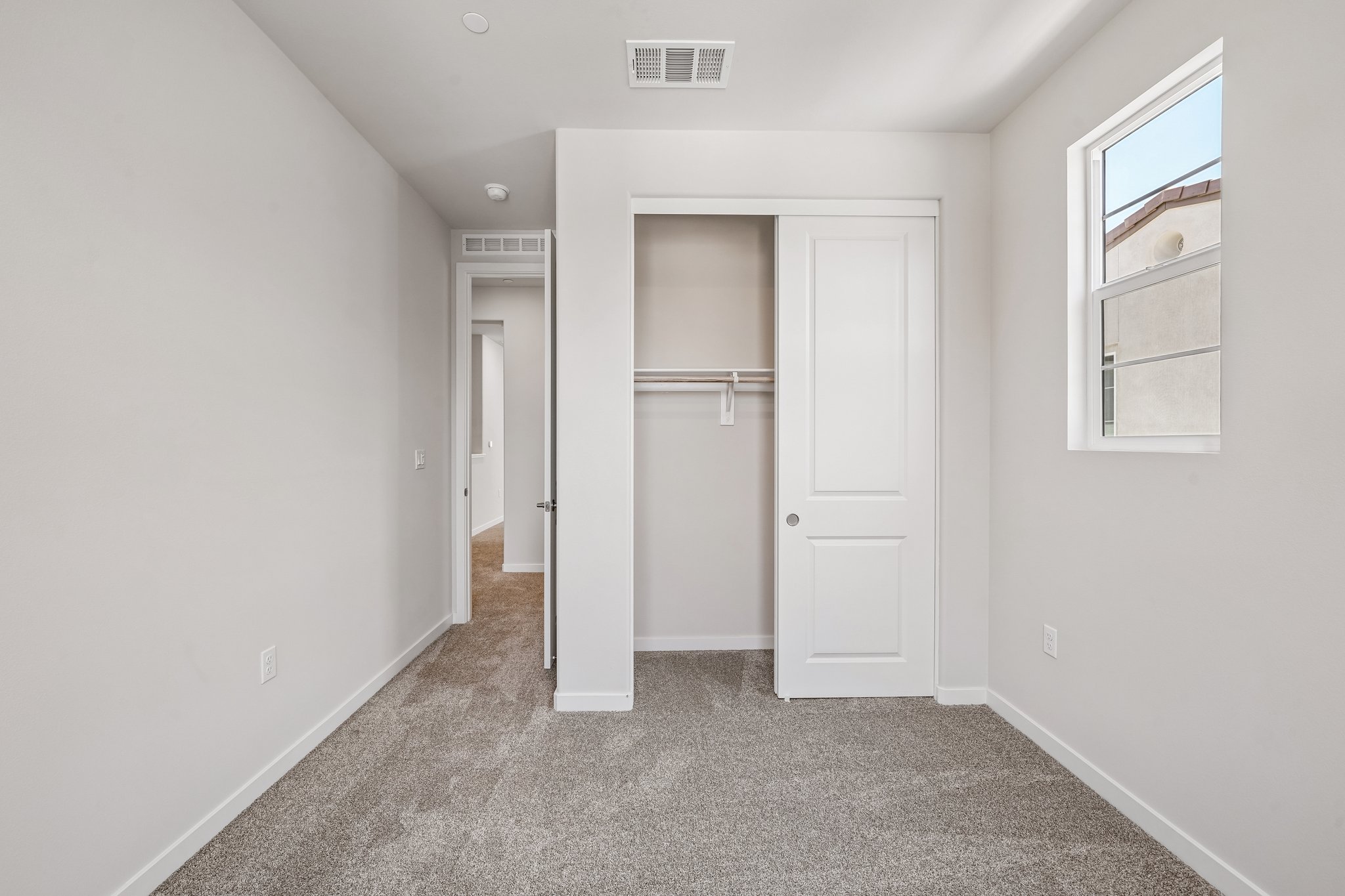 A hallway with white doors.