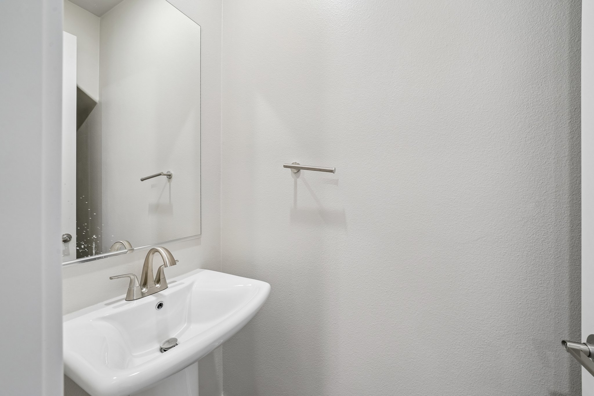 A bathroom with a mirror and sink.