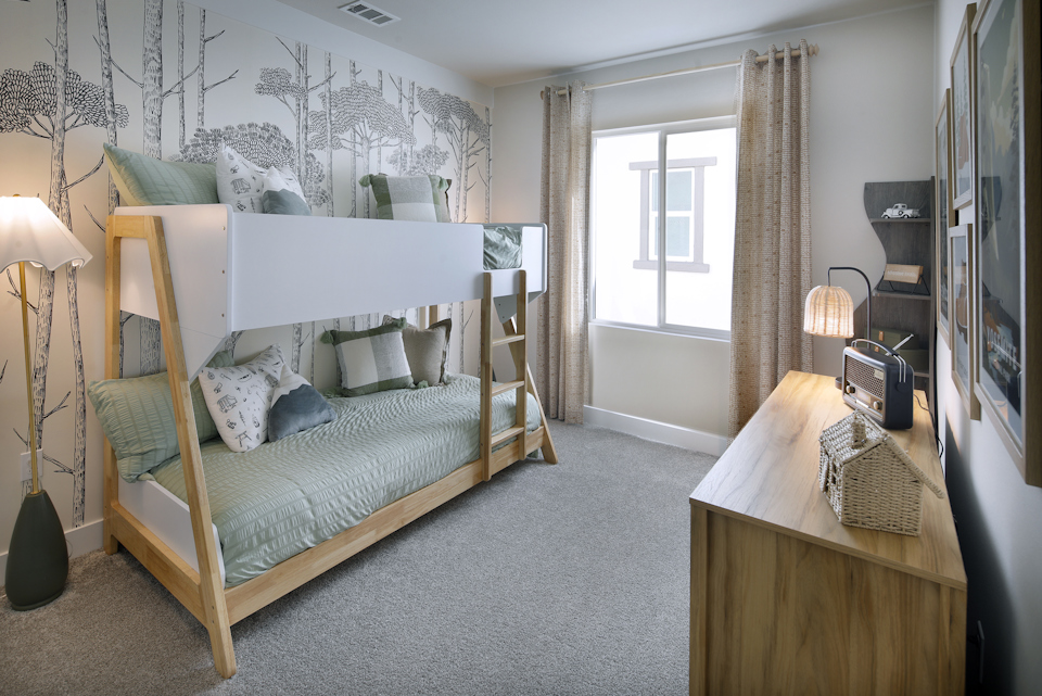 A bedroom with a bed and a desk.