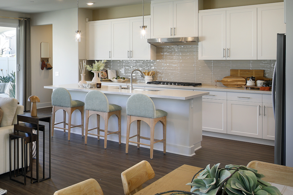 A kitchen with white cabinets.