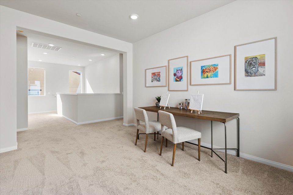 A room with a table and chairs.