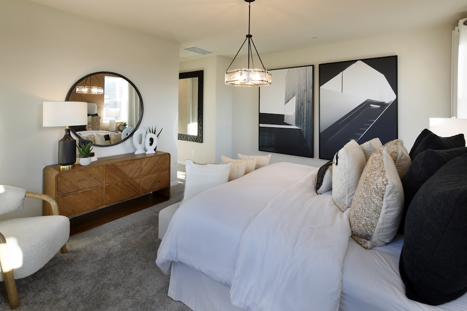 A bedroom with a bed and a couch.