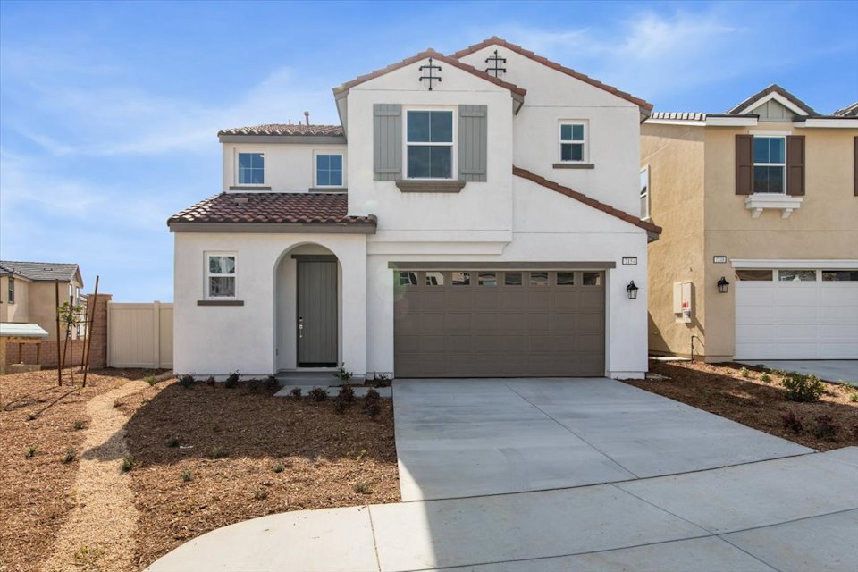 A white house with a garage.