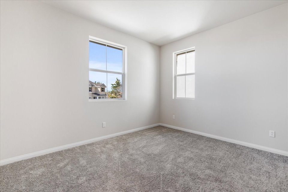 A room with a window and a carpet.