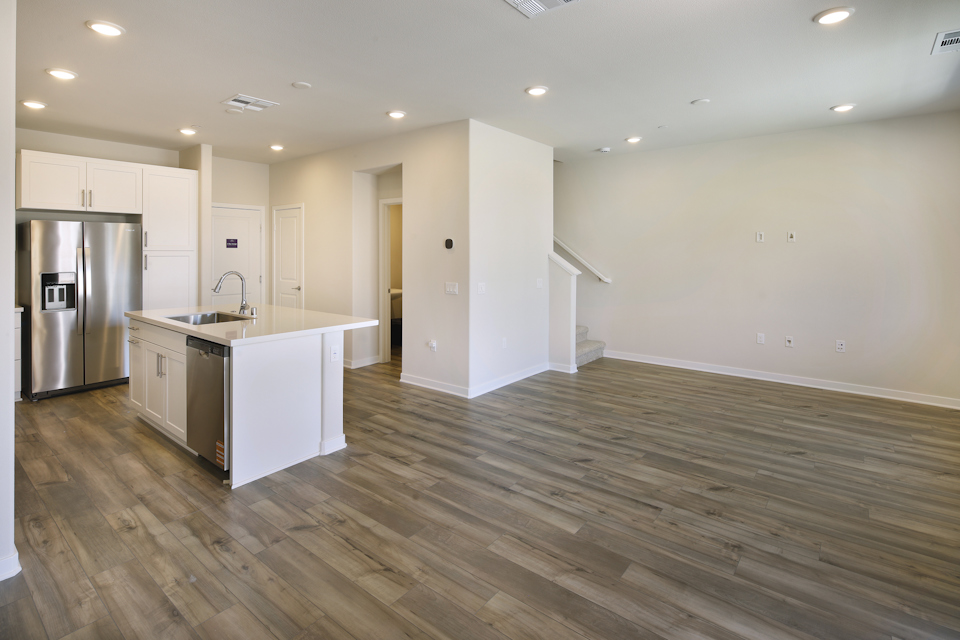 A kitchen with white cabinets.