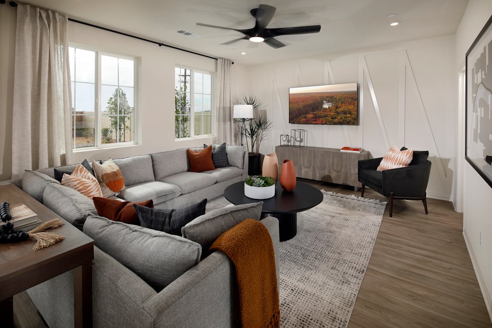 A living room with a couch and a table.