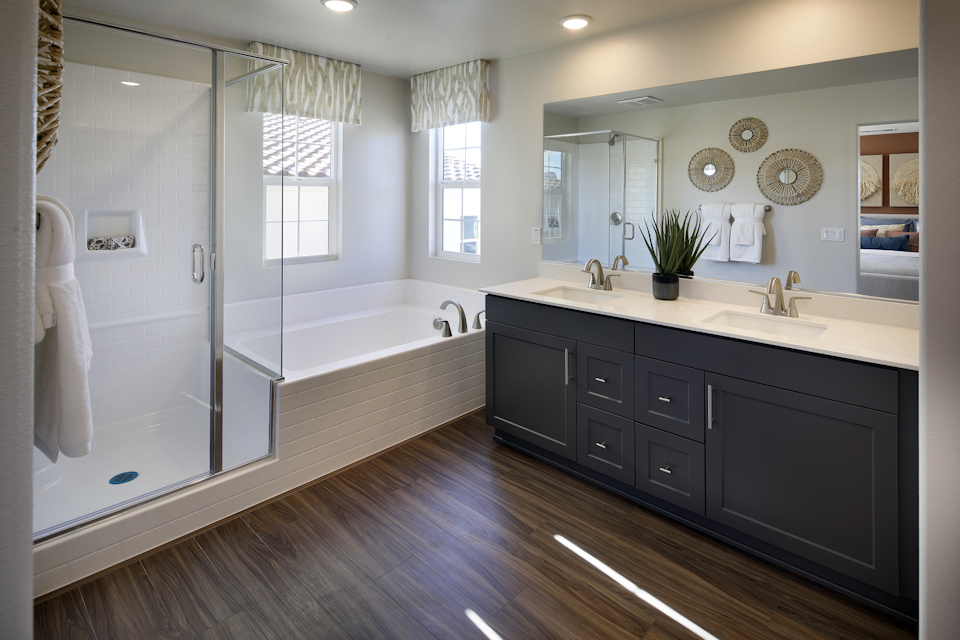 A bathroom with a tub sink and a shower.