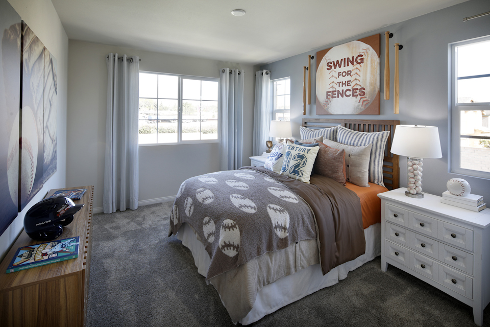 A bedroom with a bed and a dresser.