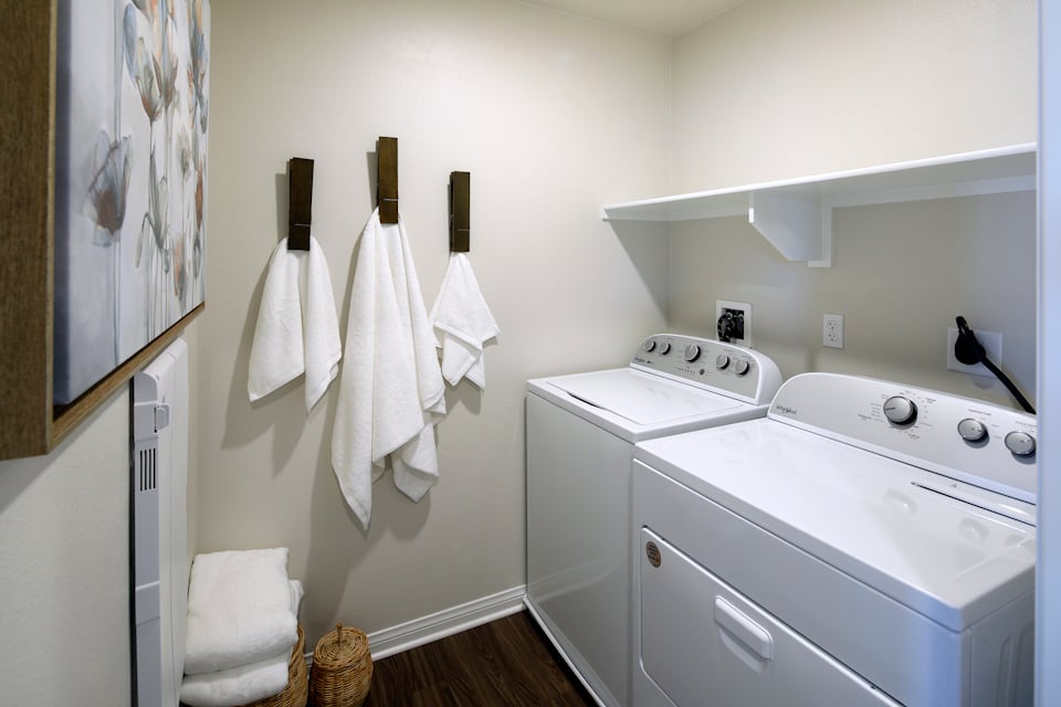 A white kitchen with a white stove and white cabinets.