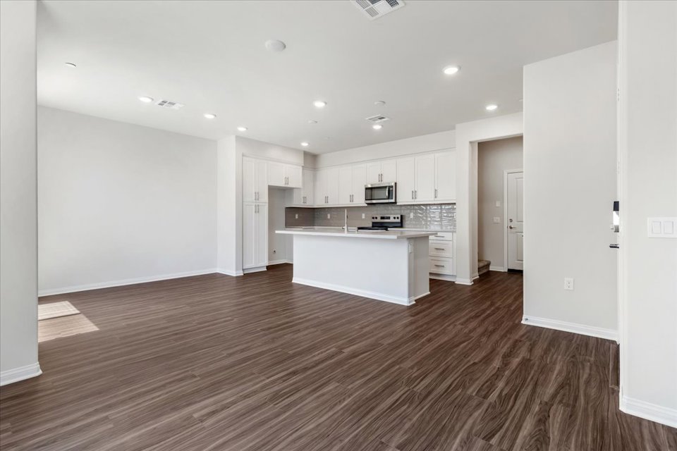 A large kitchen with white cabinets.