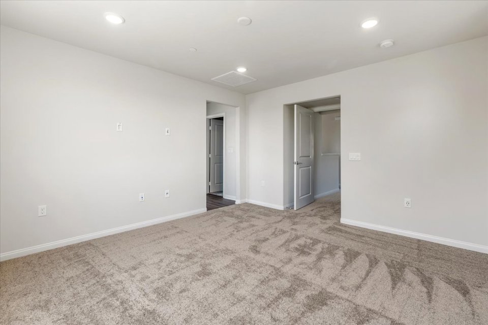 A room with a carpet and a rug.