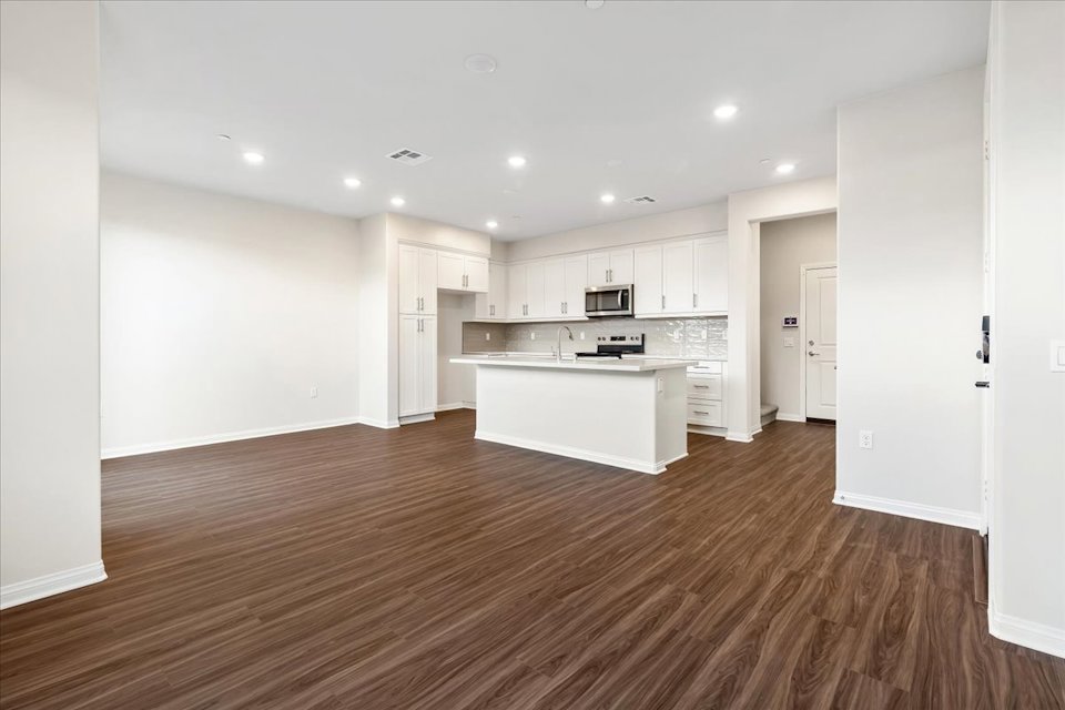 A large kitchen with white cabinets.
