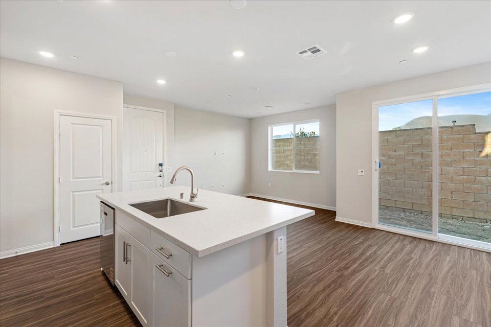 A kitchen with white cabinets.