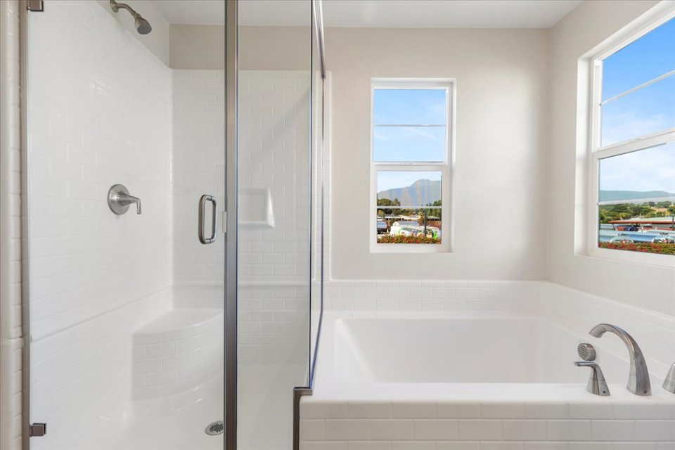 A bathroom with a tub and a window.