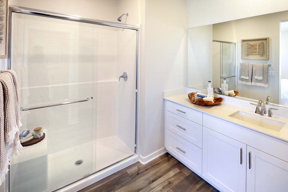A bathroom with a shower and sink.