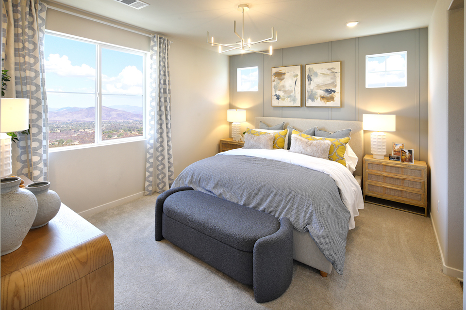 A bedroom with a large window.