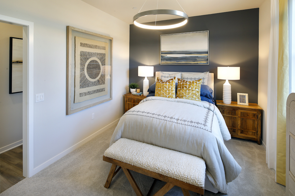 A bedroom with a bed and lamps.