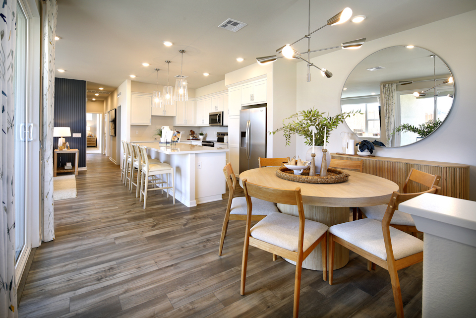 A large kitchen with a dining table.
