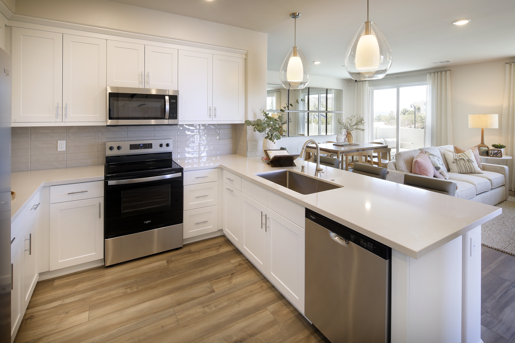 A kitchen with white cabinets.