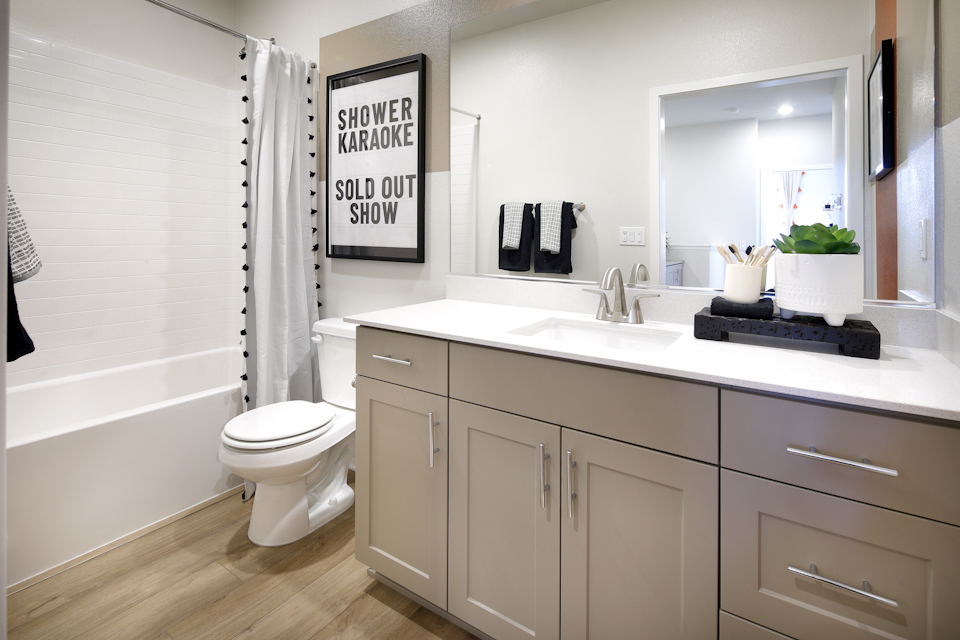 A bathroom with a tub sink and toilet.